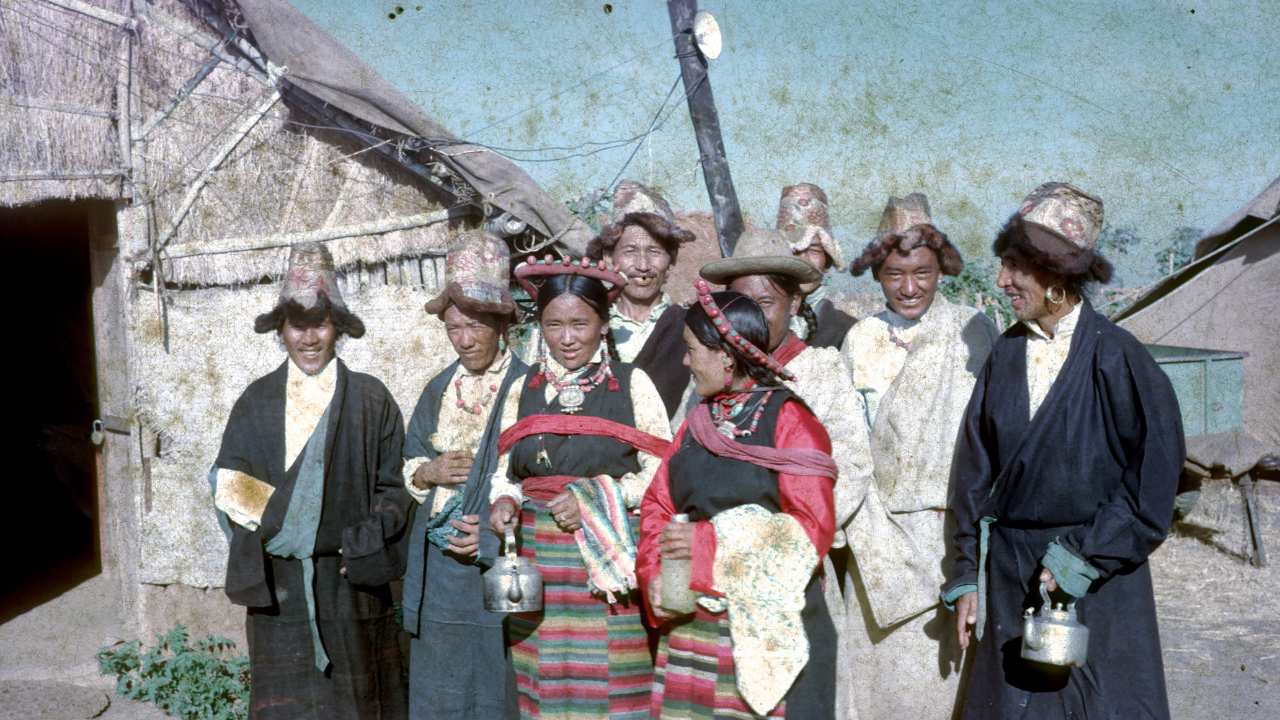 a group of people with hats smiling toether
